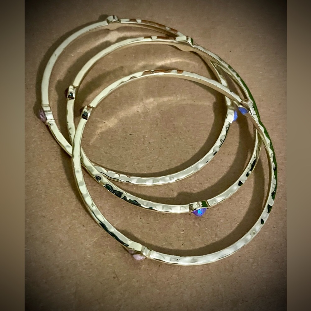 Kendra Scott Bangles set with purple precious stones.